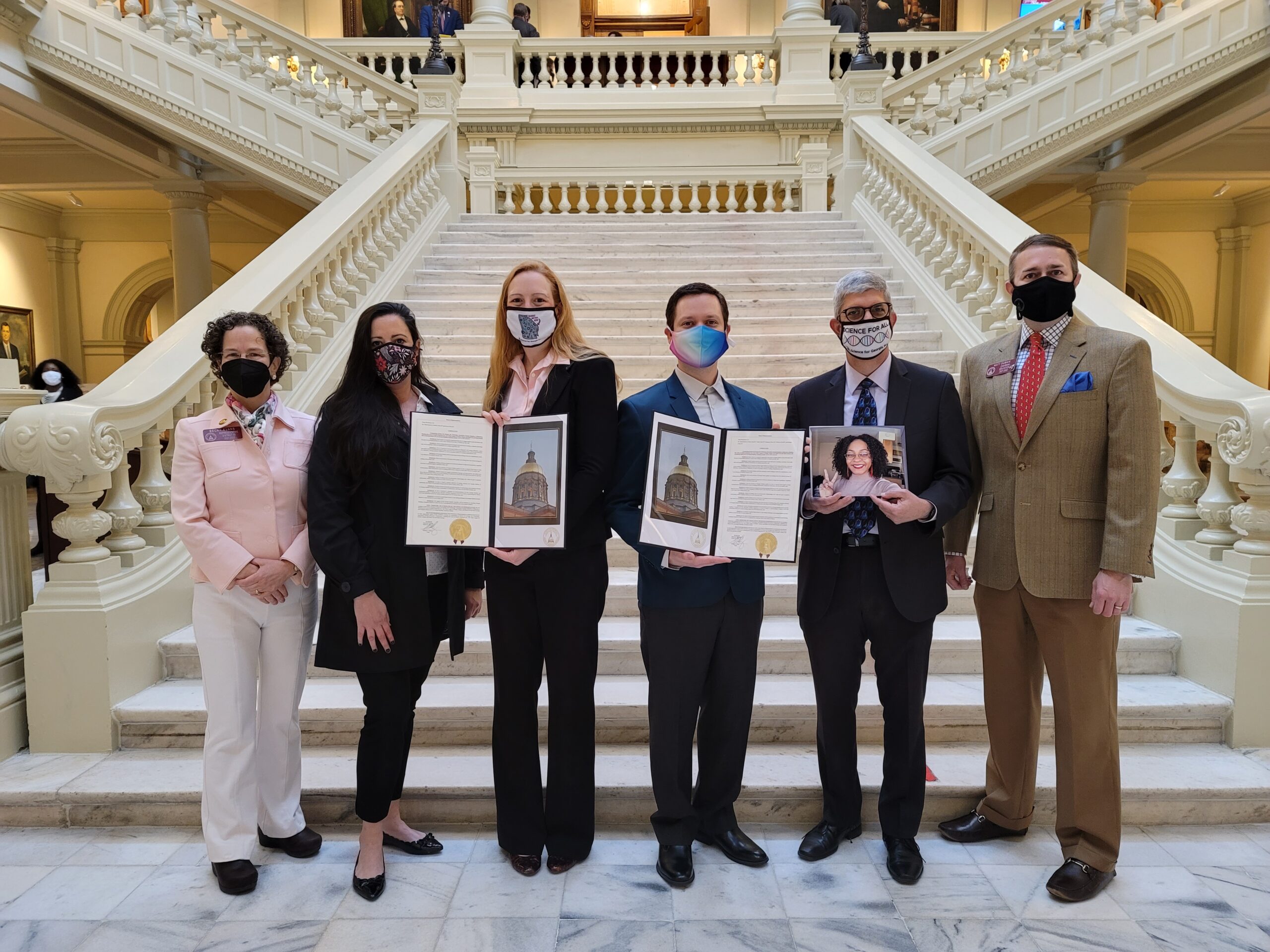 From left to right, Rep Becky Evans, Amy Sharma (Science for Georgia), Karolina Klinker (Reach Out and Read), Louis Kiphen (Science for Georgia), Randy Gorod (Sci4Ga - holding a photo of Paige Greenwood), and Rep Matt Dubnik.